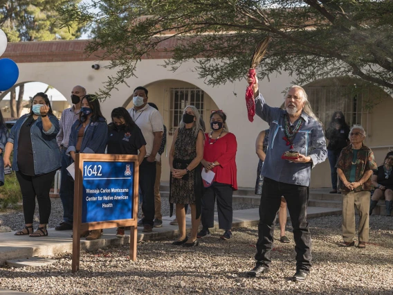 Carlos Gonzales, MD, assistant dean of curricular affairs, associate professor of Family and Community Medicine, and advisor for Traditional Indian and Western Medicine Collaboration, says a prayer to the Seven Sacred Directions during the renaming ceremony.