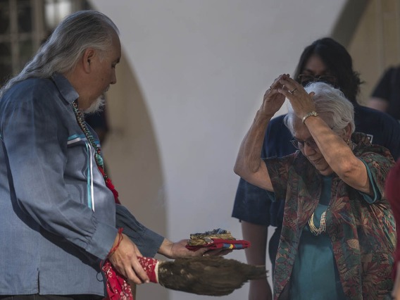 Carlos Gonzales, MD, performs a smudging ceremony, where he blesses each person with the smoke of the sacred cleansing and blessing herbs, which is burned in an abalone shell.