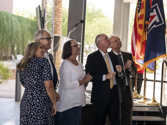 The Coit family along with President Robbins and Pharmacy Dean Schnellmann take in the new R. Ken Coit College of Pharmacy signage on the side of the building after the unveiling ceremony. 