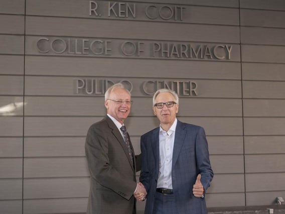 College of Pharmacy Dean Dr. Rick G. Schnellmann, left, thanks R. Ken Coit for his $50 million gift to the newly named R. Ken Coit College of Pharmacy after the unveiling ceremony. “I’ve been smiling for a week,” said Dr. Schnellmann.