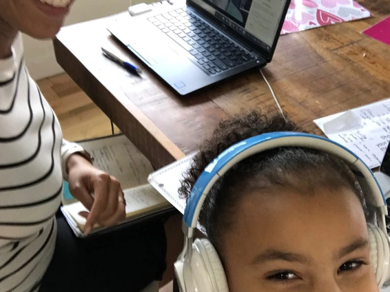 Allison Otu, executive director of corporate and community relations, poses for a photo with her daughter while working from home.