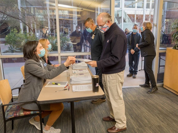 At a University of Arizona Campus Health vaccine distribution site, people walk in for their appointment to be vaccinated. 