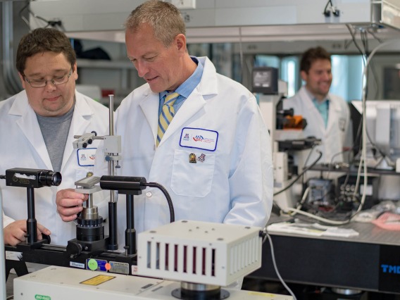 In this 2017 photo, Frederic Zenhausern, PhD, MBA, right, director of the Center for Applied NanoBioscience and Medicine, works with Matthew Barrett, a senior research specialist.