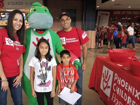 Dr. Rastogi and family at a Diamondbacks game volunteering for Phoenix Children's Hospital