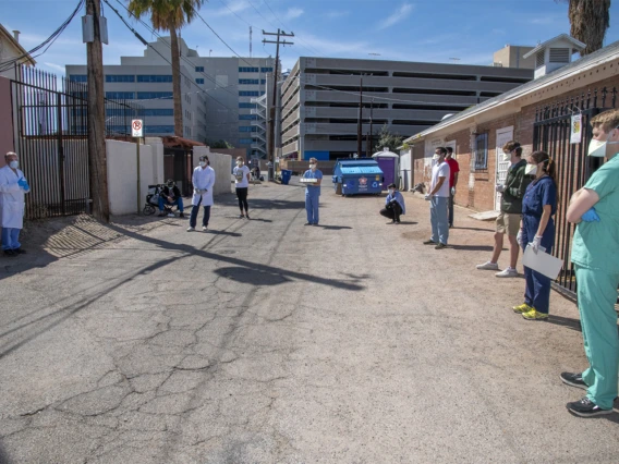 College of Medicine – Tucson students meet downtown before offering health care services to Tucson’s vulnerable homeless population amid the COVID-19 pandemic.