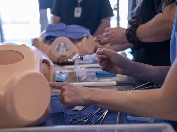 Students practice chest tube insertion during  intensive clinical skills training at ASTEC. 