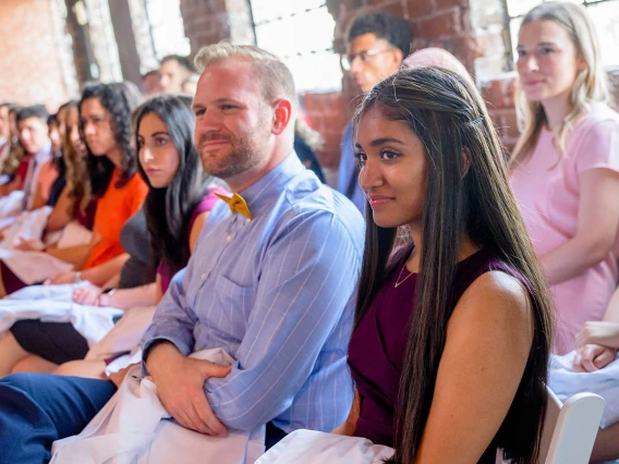 Dexter Gulick, Rachna Guntu and other new medical students listen to the speakers during the ceremony.