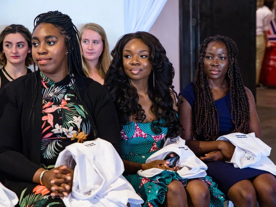 Kristie Nonyelu, Chikaodinaka Ohaya, Tracy Okonya, Theresa Riley and Rachel Russell listen to the speakers during the ceremony.