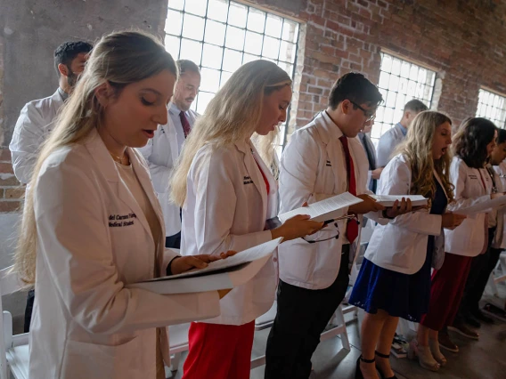 Sofia Fabrega, Nicole Falls, Saul Favila, Blake Feldmar and fellow med students read their oath during the ceremony.