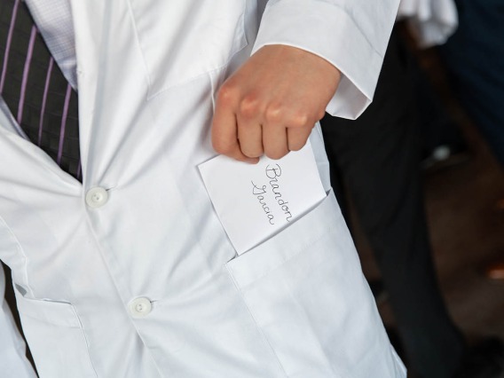 Brandon Garcia discovers a personal note in the pocket of his white coat. The notes are a traditional part of the white coat ceremonies.