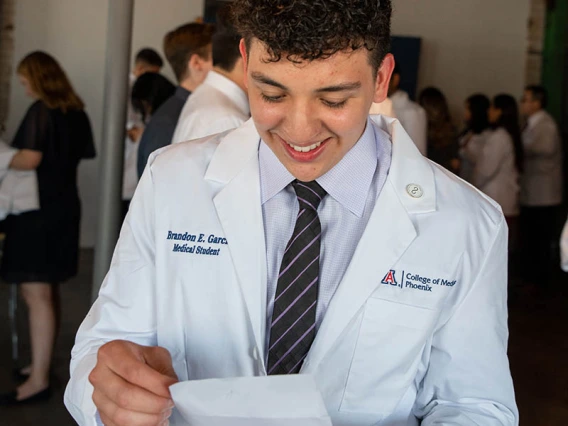 Brandon Garcia reads his personal white coat note.