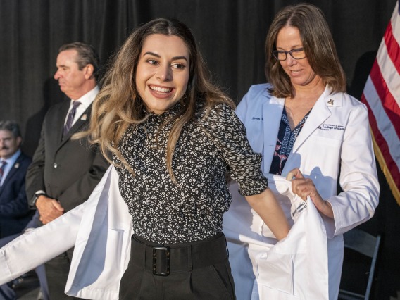 Natalie Nabaty receives her white coat from Susan Kaib, MD, FAAFP, at the class of 2025 University of Arizona College of Medicine – Phoenix white coat ceremony.