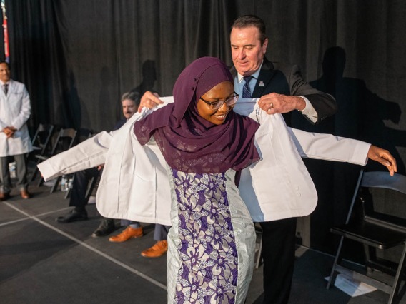 Primary Care Scholarship recipient Fatouma Tall receives her white coat during the White Coat Ceremony at the UArizona College of Medicine – Phoenix on July 16.