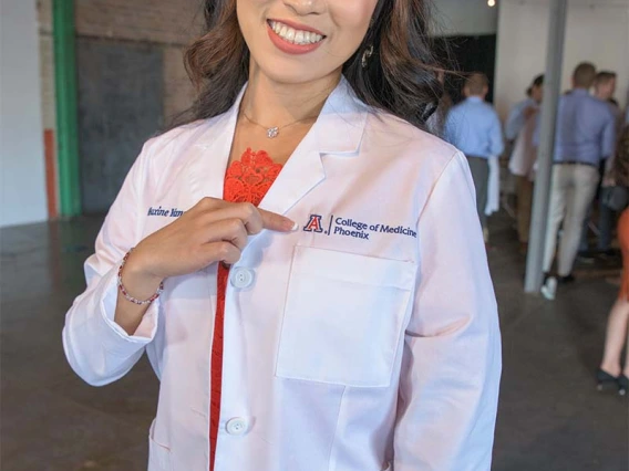 Maxine Yang proudly shows off her UArizona College of Medicine – Phoenix white coat before the ceremony.