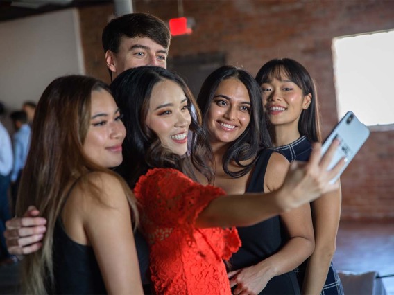 From left, Theresa Bui, Maxine Yang, Vrishti Shah, Yerina Cho and Trevor Smith (back) take a selfie-for-five after the white coat ceremony.