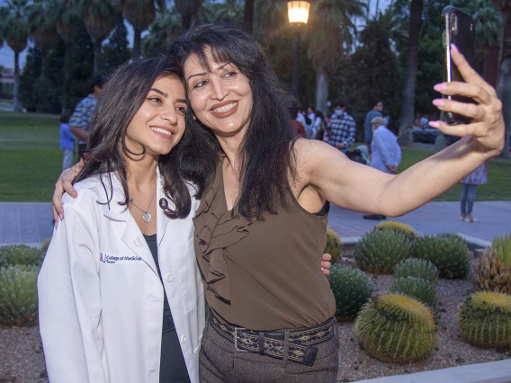 UArizona College of Medicine – Tucson student Pantea Sazegar and her mother Sohaila Samiei capture the moment with a selfie after the white coat ceremony.¬¬