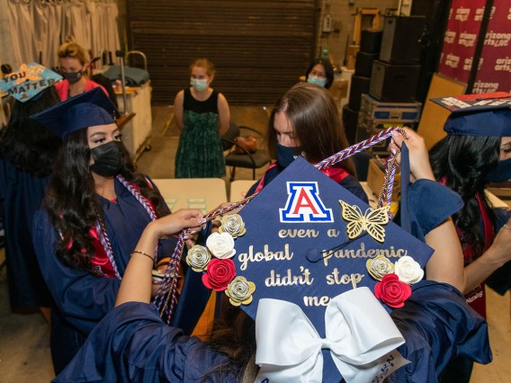 College of Nursing graduates prepare backstage at Centennial Hall before their commencement ceremony.
