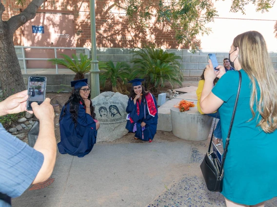 Rita Morado (left) and Valeria Pena-Quijada pose for a photo after the August commencement.