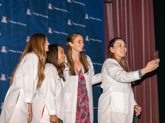 Doctor of Nursing Practice students (from left) Tyra Hepworth, Paige Nyland, Stephanie Gasser and Cynthia Hill take a selfie after the white coat ceremony. 