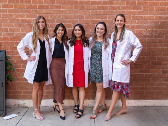 Doctor of Nursing Practice students (from left) Tyra Hepworth, Sherry Nguyen, Paige Nyland, Cynthia Hill and Stephanie Gasser gather for a photo after their white coat ceremony. 