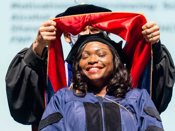 Christiana Billedalley, who completed her Doctor of Nursing Practice degree, is hooded during the College of Nursing convocation in December at Centennial Hall.