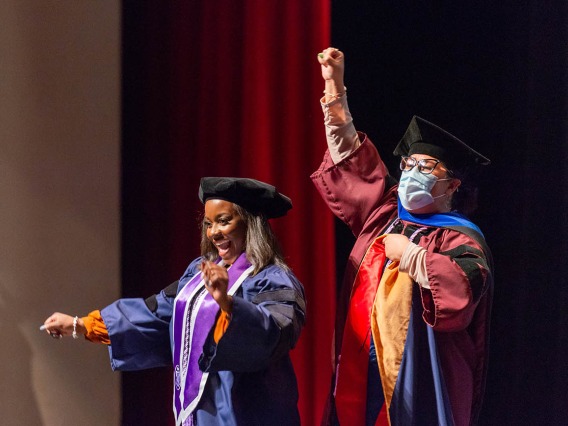 Yarmoni Yharbough (left) and her committee chair Evangeline Dowling, PhD, MSN/Ed, celebrate after Yharbough is hooded for earning her Doctor of Nursing Practice during the College of Nursing fall convocation.