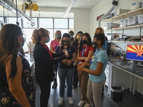 Deana Ann Smith, RN, health care simulation educator for ASTEC (second from left), takes  middle school girls from the ACES camp on a tour of the tissue lab. 