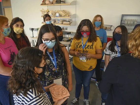 ACES campers take a look at simulated skin made in the ASTEC tissue lab. The skin is used by Health Science students to practice suturing.