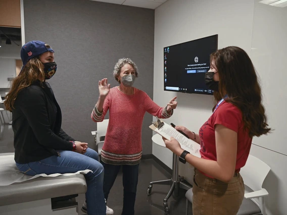 ACES camper Leia Switzer, left, had a chance to act as a patient while Ayleen Cruz, right, was the doctor during a simulated clinical skills rotation. Clinical skills volunteer patient, Claudia Orecka-Teplitsky, center, gave them feedback after they finished their simulation.