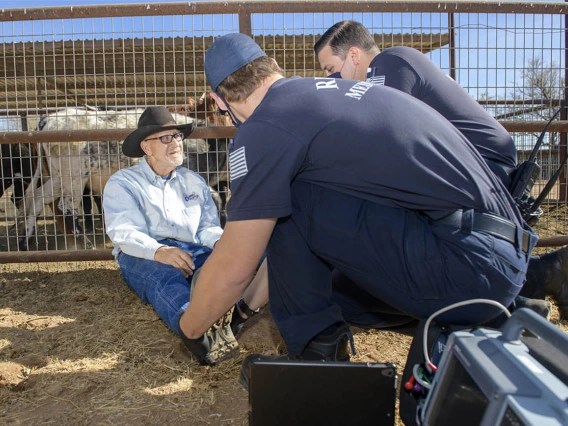 Weber and Saenz talk to the patient to prepare him for examination. (Note: This was a simulated accident scene for demonstration purposes.)