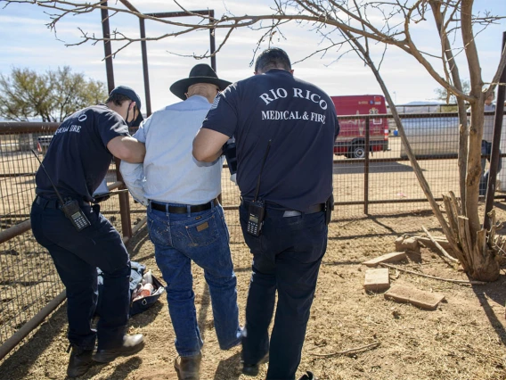 Weber and Saenz help Keller walk to the ambulance. (Note: This was a simulated accident scene for demonstration purposes.)