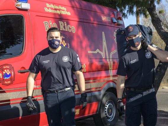 Rio Rico emergency medical technicians Luis Saenz and Nick Weber approach an accident scene to tend to a patient with an ankle injury. (Note: This was a simulated accident scene for demonstration purposes.)