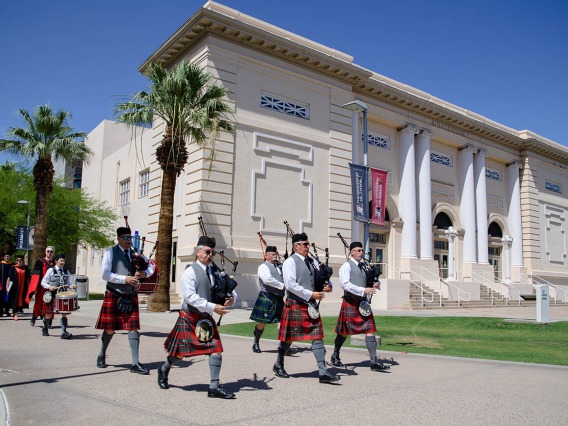 The College of Medicine – Phoenix class of 2022 is led by a pipe and drum corps through the streets of downtown Phoenix to their commencement ceremony at the Phoenix Convention Center.