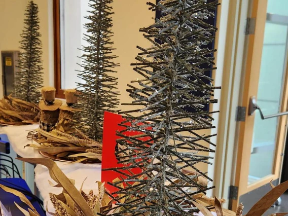 Wooden Christmas trees and fluffy cotton “snow” adorn the reception desk and lobby of Building 1 at the Phoenix Bioscience Core.