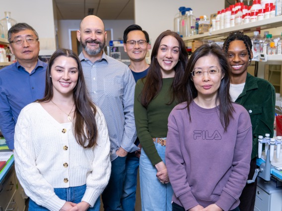 group of researchers pose in a College of Medicine – Phoenix laboratory