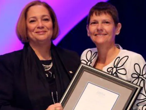 Valerie Jackson, MD, president of the RSNA (left), presents the Outstanding Researcher of 2019 Award to Elizabeth Krupinski, PhD.