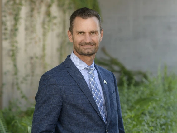 Man wearing a blue suit smiling