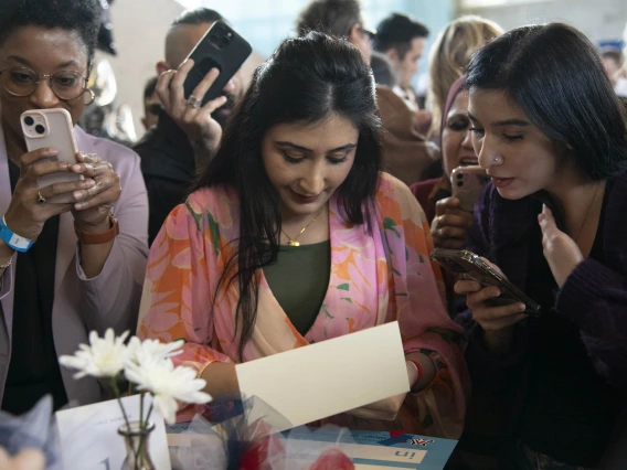 Two women read a sheet of paper at the University of Arizona College of Medicine – Phoenix Match Day celebration.