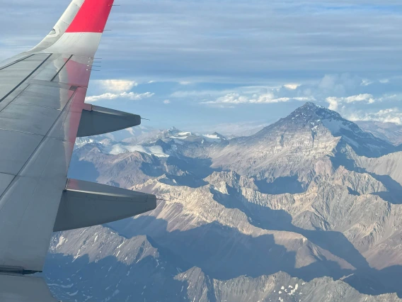 View of a plane’s wing with Aconcagua in the background. 