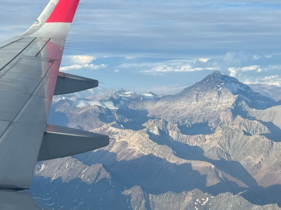 View of a plane’s wing with Aconcagua in the background. 