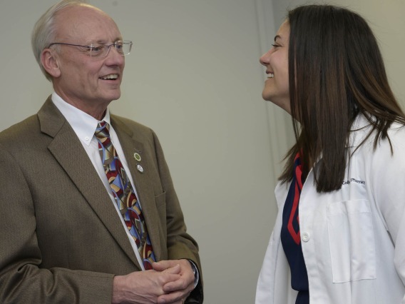 University of Arizona College of Pharmacy Dean Rick Schnellmann smiles as he talks with Ashley Campbell, a professor.   