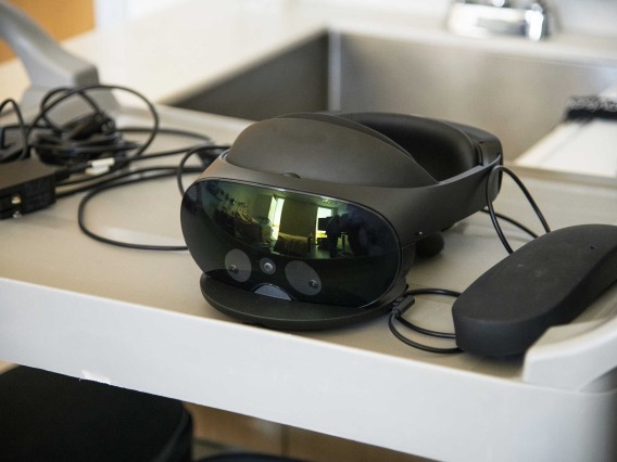 A virtual reality headset sits on a table.