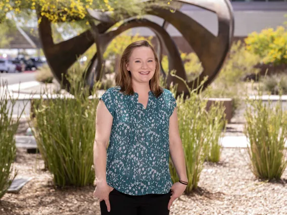 Portrait of Kathryn Emerick outside in front of a sculpture