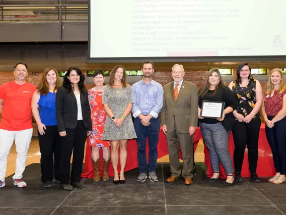 Members of the PeerWORKS and Project FUTRE team accept the Team Award for Excellence from Interim Provost Ronald Marx.