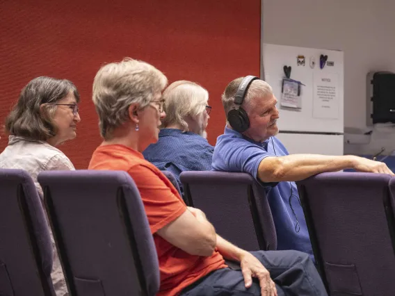 Four people, including Mel Hector, MD, of the University of Arizona’s College of Medicine – Tucson, watch a reading of Hector’s play.