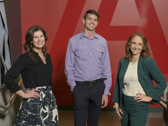 Portrait of Rina Fox, PhD, MPH; Nathan Lothrop, PhD; and Alaina F. Krone; standing next to each other in front of a University of Arizona logo.