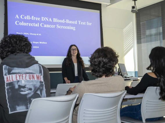 U of A College of Health Sciences student Hope Wollen in front of a class giving a presentation on colorectal cancer screenings