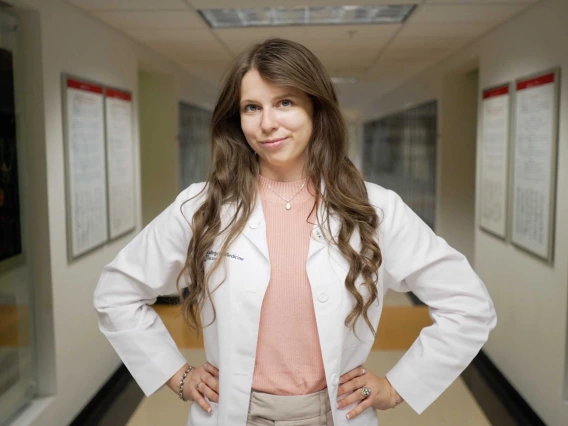 portrait of Jillian Leaver wearing a white coat and standing in front of the University of Arizona Health Sciences Innovation Building