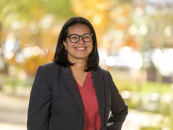 Portrait of Gabriela Valdez, PhD, standing outside. 