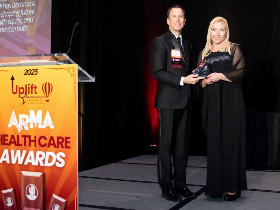 Jason Jameson, MD, hands award to Jennifer Hartmark-Hill.